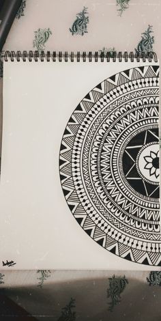 a spiral notebook with a black and white design on it