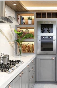 a modern kitchen with stainless steel appliances and white counter tops, along with open shelving