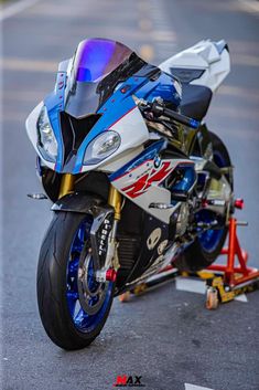 a blue and white motorcycle parked on the street