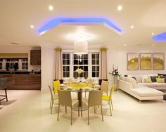 a living room filled with furniture and a dining table