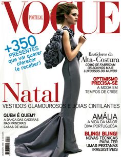 the cover of a magazine with a woman in a long gray dress and flowers on it