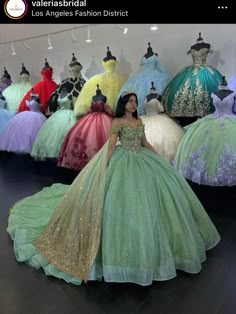 a woman standing in front of dresses on display