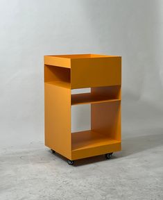 an orange shelf sitting on top of a white floor