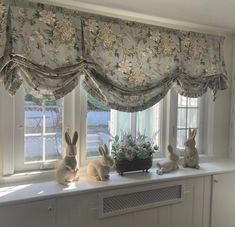 the window sill is decorated with bunnies and flowers