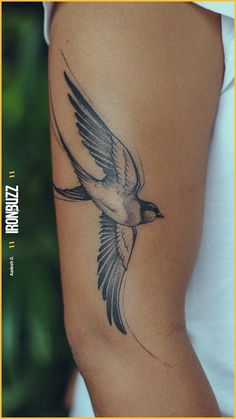 a woman's thigh with a bird tattoo on it