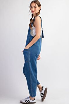 Mineral washed solid sleeveless jumpsuit featuring adjustable straps, a scoop neckline, two open front pockets and is a straight leg style. Model is 5'9" and wearing a small.75%COTTON 23%POLYESTER 2%SPANDEX Spring Medium Wash Overalls With Adjustable Straps, Casual Cotton Jumpsuits And Rompers With Tie Straps, Casual Solid Jumpsuits And Rompers With Adjustable Straps, Casual Shortalls With Side Pockets, Blue Overalls With Adjustable Straps For Spring, Spring Blue Overalls With Adjustable Straps, Casual Jumpsuits And Rompers With Adjustable Straps, Casual Dark Wash Bib Front Overalls, Casual Cotton Overalls With Tie Straps