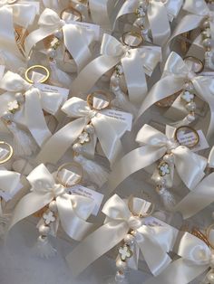 many white bows with gold rings on them