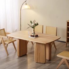 a wooden table and chairs in a room