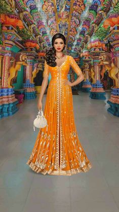 a woman in an orange and gold dress standing on the floor with her hands on her hips