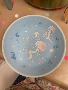 a blue bowl with jelly fish on it