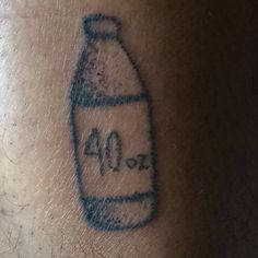 a bottle with the number 40 on it is shown in this tattoo photo taken by an unknown person