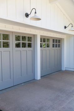 two garage doors are open in front of a house