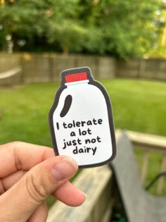 someone holding up a sticker that says i tolergate a lot just not dairy