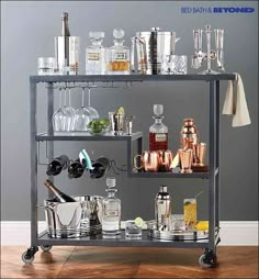 a metal bar cart filled with lots of liquor bottles and glasses on top of it