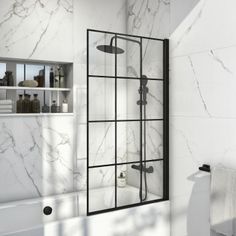 a bathroom with white marble walls and flooring, including a shower stall in the corner