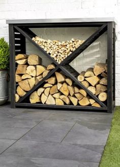 an outdoor fireplace with logs stacked in it