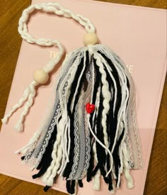 Black and white yarn and white lace with a hidden red ceramic heart bead inspired by one of my favorite Bible verses “Above all else, guard your heart, for everything you do flows from it” 
Proverbs 4:23 Diy Bible Tassel Bookmark, Diy Ribbon Bookmarks, Tassel Bookmark Diy, Tassle Bookmarks, Diy Bible Tassels, Bible Tassel Bookmark Diy, Bible Bookmarks Diy, Diy Yarn Tassel