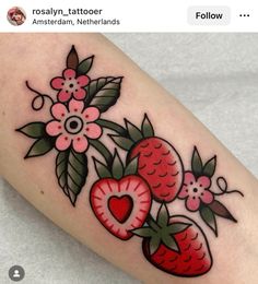 a tattoo with strawberries and flowers on it