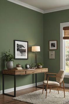 a room with green walls and a wooden desk in front of a window that has pictures on the wall