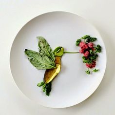 a white plate topped with greens and radishes