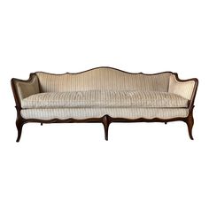 an antique style couch with wooden frame and upholstered fabric on the back end