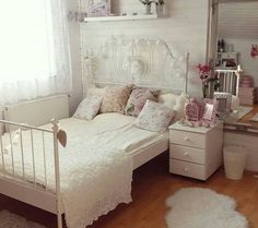 a white bed sitting in a bedroom next to a dresser with drawers on top of it