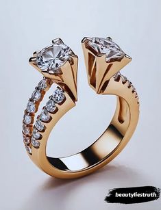 a gold ring with two diamonds on top and side stones in the middle, set against a white background