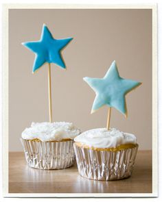 two cupcakes with blue and white stars on them