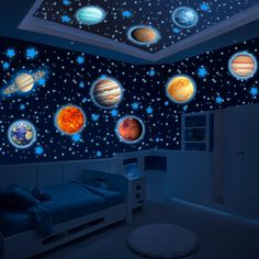 a bedroom with planets and stars on the wall