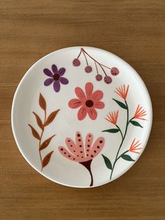 a white plate with flowers painted on it