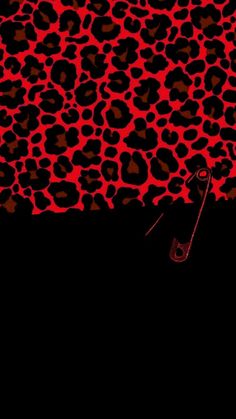 a red and black animal print background with scissors