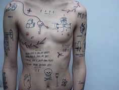 a man with many tattoos on his chest