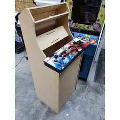 an old fashioned arcade machine in the process of being built into a cardboard stand up