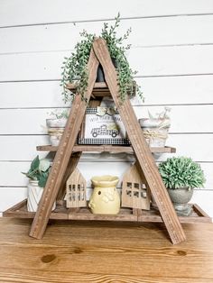 a wooden shelf with plants and other items on it