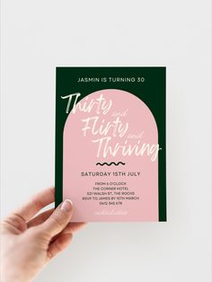 a hand holding up a pink and green wedding card with the words, that says'just