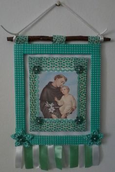 a green and white frame with a picture of a man holding a baby on it