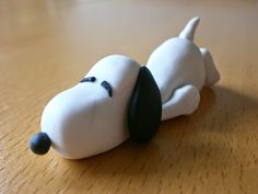 a small toy dog laying on top of a wooden table