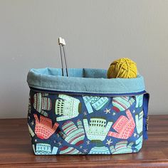 a knitting needle case on a table with yarn and crochet hooks in it