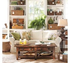 a living room filled with furniture and lots of shelves full of books on top of them