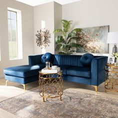 a living room filled with blue couches and tables on top of a wooden floor