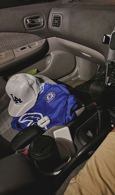 the interior of a car with hats and other items in it, including a baseball cap