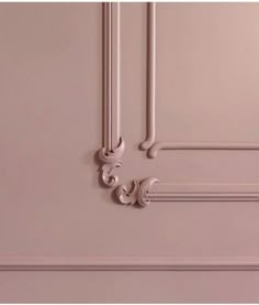 the door is painted pink and has ornate designs on it's side paneling