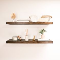 two wooden shelves with candles and other items on them