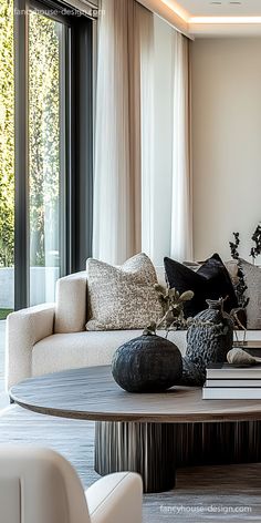 The luxurious layering of natural fabrics, smooth marble, and subtle metallic accents creates depth in this contemporary lounge.