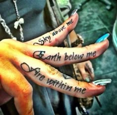 two people with tattoos on their hands and one has the words earth below them,