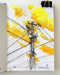 an open book with yellow and black ink on it, featuring power lines in the background