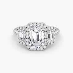 an emerald - cut diamond ring set with round brilliant diamonds