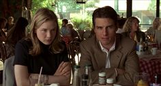 a man and woman sitting at a table in a restaurant