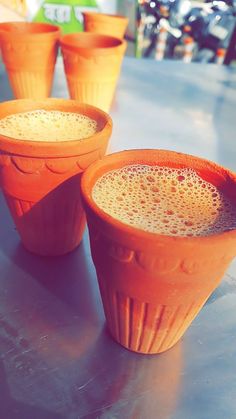 three orange cups sitting on top of a table