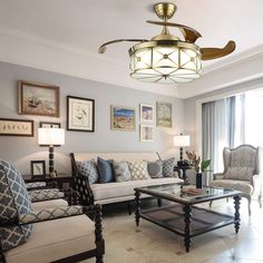 a living room filled with furniture and a ceiling fan